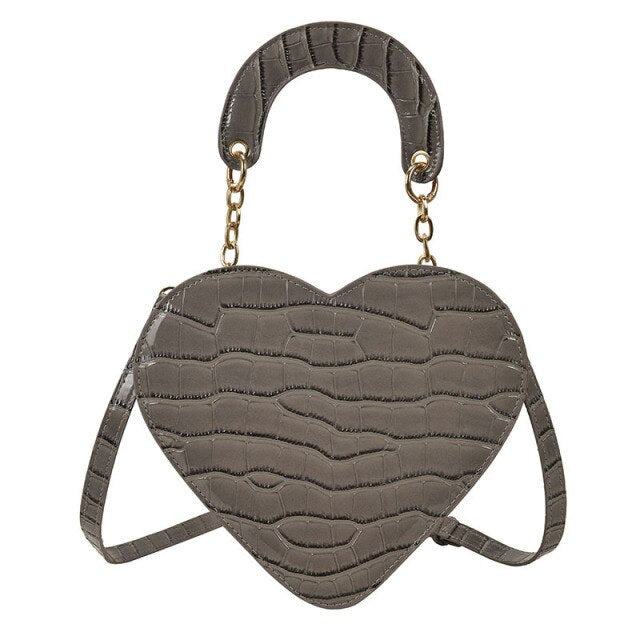 Cute Heart Shaped Design Purse This professional-looking yet stylish Cute Heart Shaped Design Purse is perfect for the fashion-forward woman. Thoughtfully designed with quality Pu Leather (Artificial Leather), this chic and eye-catching purse offers a gir