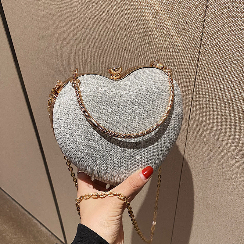 New Fashion Chain Crossbody Explosion Handheld Peach Heart Bag Product information: Color: black, gold, silver Material: Acrylic Luggage trend style: heart shaped bag Bag size: small Popular element: chain Lining texture: polyester Bag shape: heart Cover