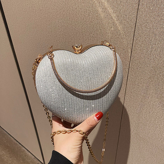 New Fashion Chain Crossbody Explosion Handheld Peach Heart Bag Product information: Color: black, gold, silver Material: Acrylic Luggage trend style: heart shaped bag Bag size: small Popular element: chain Lining texture: polyester Bag shape: heart Cover