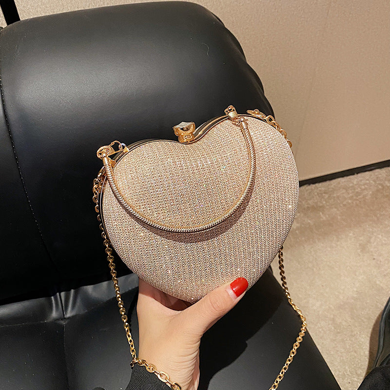 New Fashion Chain Crossbody Explosion Handheld Peach Heart Bag Product information: Color: black, gold, silver Material: Acrylic Luggage trend style: heart shaped bag Bag size: small Popular element: chain Lining texture: polyester Bag shape: heart Cover