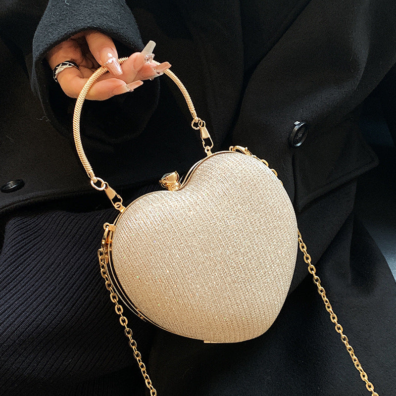 New Fashion Chain Crossbody Explosion Handheld Peach Heart Bag Product information: Color: black, gold, silver Material: Acrylic Luggage trend style: heart shaped bag Bag size: small Popular element: chain Lining texture: polyester Bag shape: heart Cover