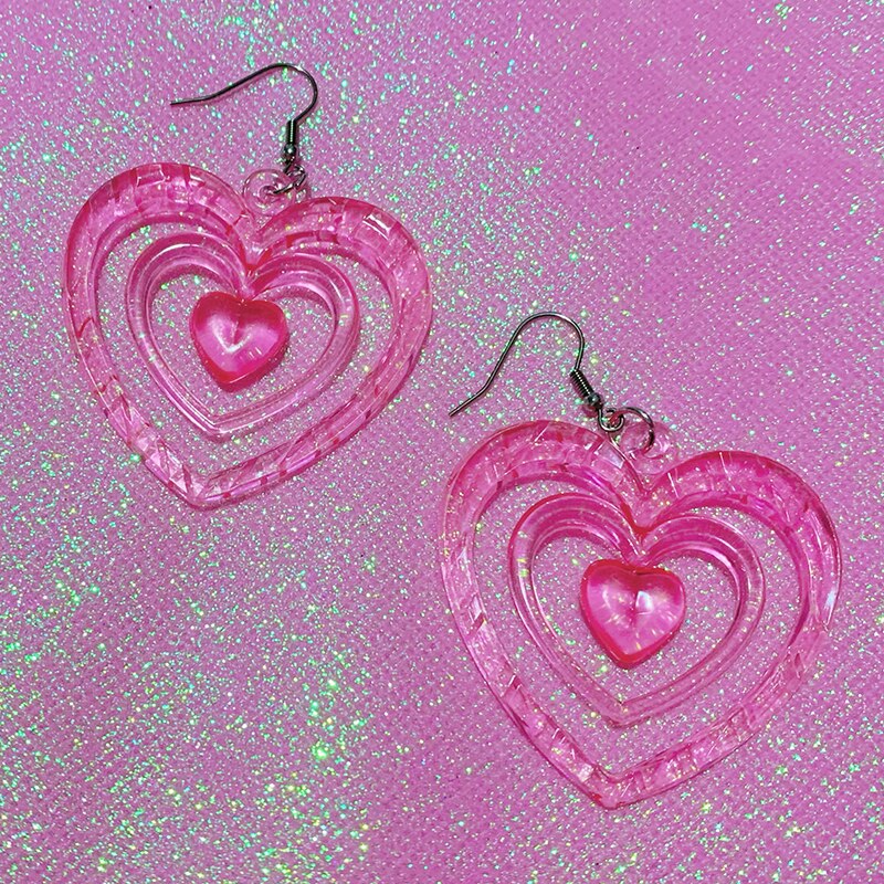 Pink Hollowout Heart Earrings Introducing our Y2K Earrings Pink Hollowout Heart Earrings, the perfect accessory to add a touch of nostalgia and vibrant style to your look. Inspired by the Y2K era, these earrings embody the essence of Korean fashion, kawai