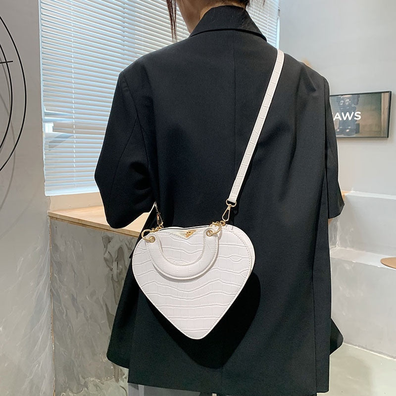 Cute Heart Shaped Design Purse This professional-looking yet stylish Cute Heart Shaped Design Purse is perfect for the fashion-forward woman. Thoughtfully designed with quality Pu Leather (Artificial Leather), this chic and eye-catching purse offers a gir