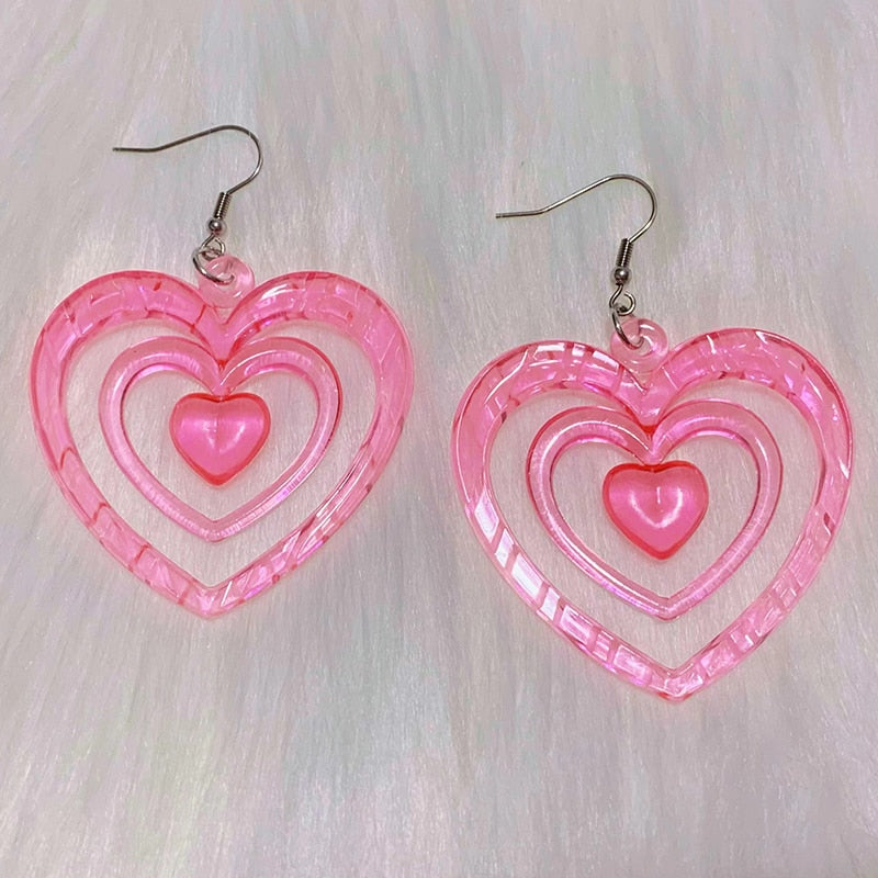 Pink Hollowout Heart Earrings Introducing our Y2K Earrings Pink Hollowout Heart Earrings, the perfect accessory to add a touch of nostalgia and vibrant style to your look. Inspired by the Y2K era, these earrings embody the essence of Korean fashion, kawai