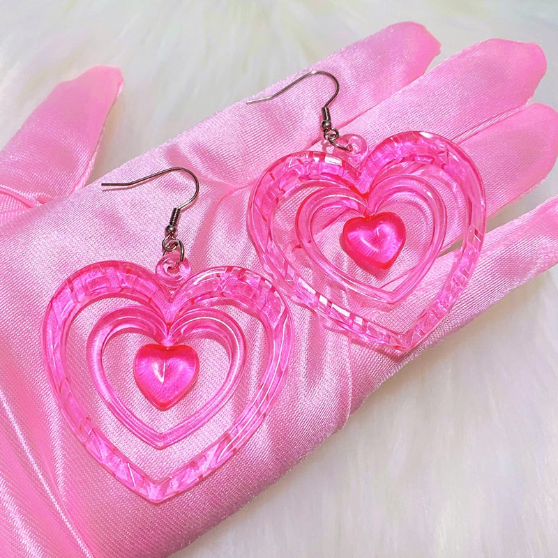 Pink Hollowout Heart Earrings Introducing our Y2K Earrings Pink Hollowout Heart Earrings, the perfect accessory to add a touch of nostalgia and vibrant style to your look. Inspired by the Y2K era, these earrings embody the essence of Korean fashion, kawai