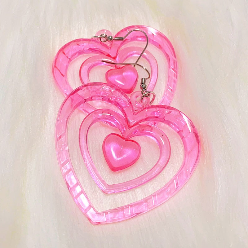 Pink Hollowout Heart Earrings Introducing our Y2K Earrings Pink Hollowout Heart Earrings, the perfect accessory to add a touch of nostalgia and vibrant style to your look. Inspired by the Y2K era, these earrings embody the essence of Korean fashion, kawai