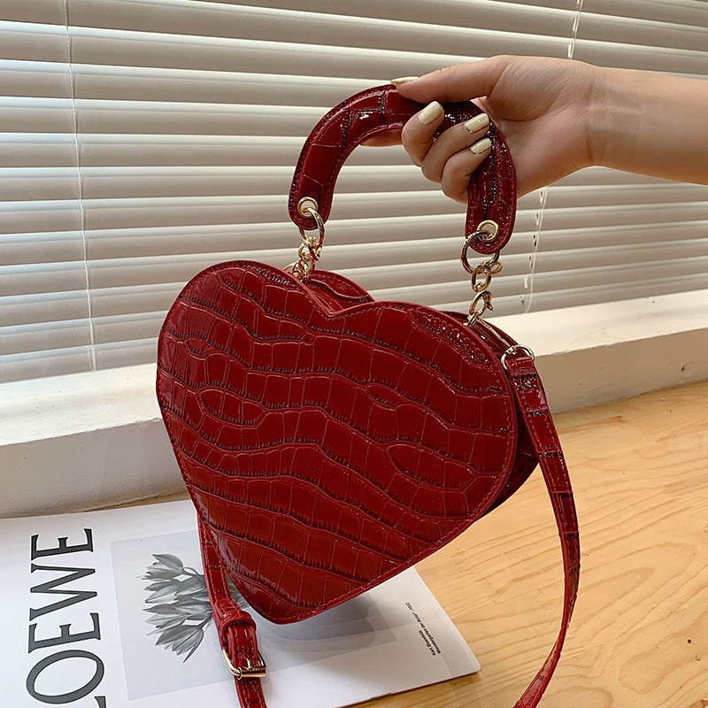 Cute Heart Shaped Design Purse This professional-looking yet stylish Cute Heart Shaped Design Purse is perfect for the fashion-forward woman. Thoughtfully designed with quality Pu Leather (Artificial Leather), this chic and eye-catching purse offers a gir
