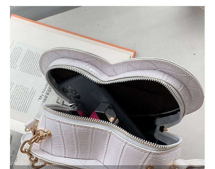 Cute Heart Shaped Design Purse This professional-looking yet stylish Cute Heart Shaped Design Purse is perfect for the fashion-forward woman. Thoughtfully designed with quality Pu Leather (Artificial Leather), this chic and eye-catching purse offers a gir