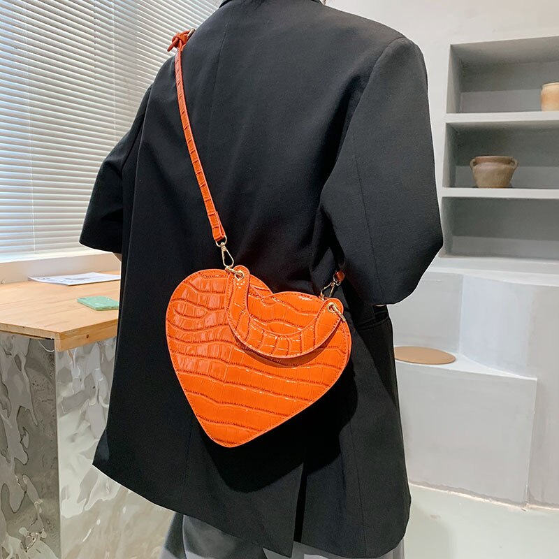 Cute Heart Shaped Design Purse This professional-looking yet stylish Cute Heart Shaped Design Purse is perfect for the fashion-forward woman. Thoughtfully designed with quality Pu Leather (Artificial Leather), this chic and eye-catching purse offers a gir