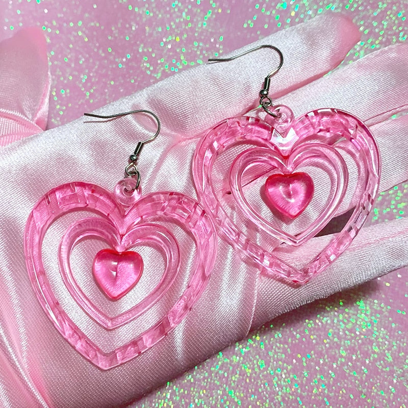 Pink Hollowout Heart Earrings Introducing our Y2K Earrings Pink Hollowout Heart Earrings, the perfect accessory to add a touch of nostalgia and vibrant style to your look. Inspired by the Y2K era, these earrings embody the essence of Korean fashion, kawai